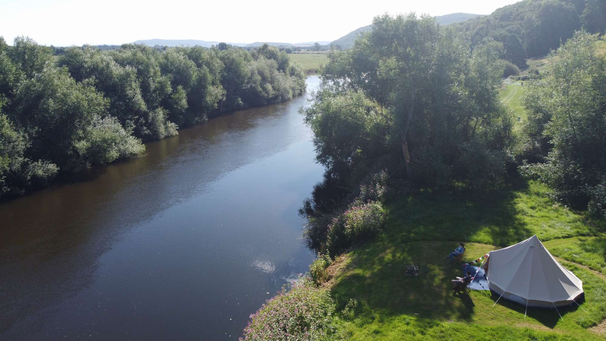 Bell tent on the riverbank